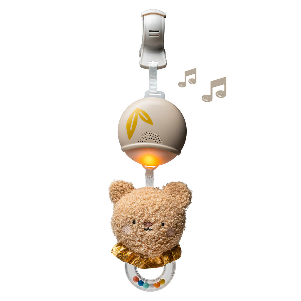 Taf Toys light up soothing bear musical toy featuring top attachment clip, glowing light orb, plush bear head, and bottom bead ring