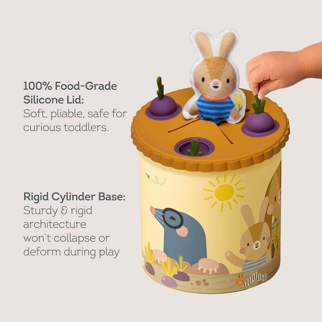 Close-up showing 100% food-grade silicone lid with beet pop-its and rigid cylinder base of Taf Toys Pop & Pull Tissue Box