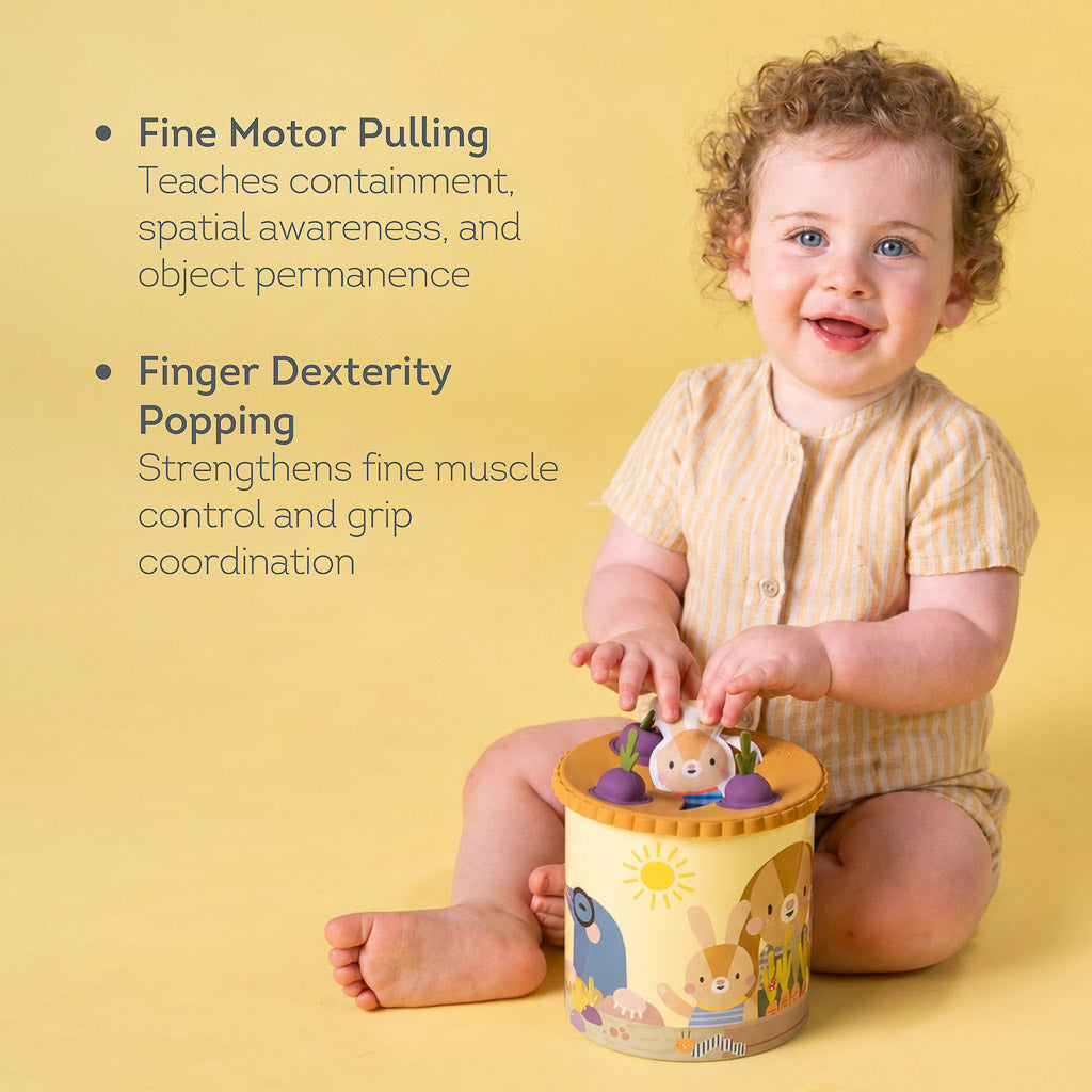 Young child engaging with Taf Toys Pop & Pull Tissue Box highlighting fine motor pulling and finger dexterity popping skills