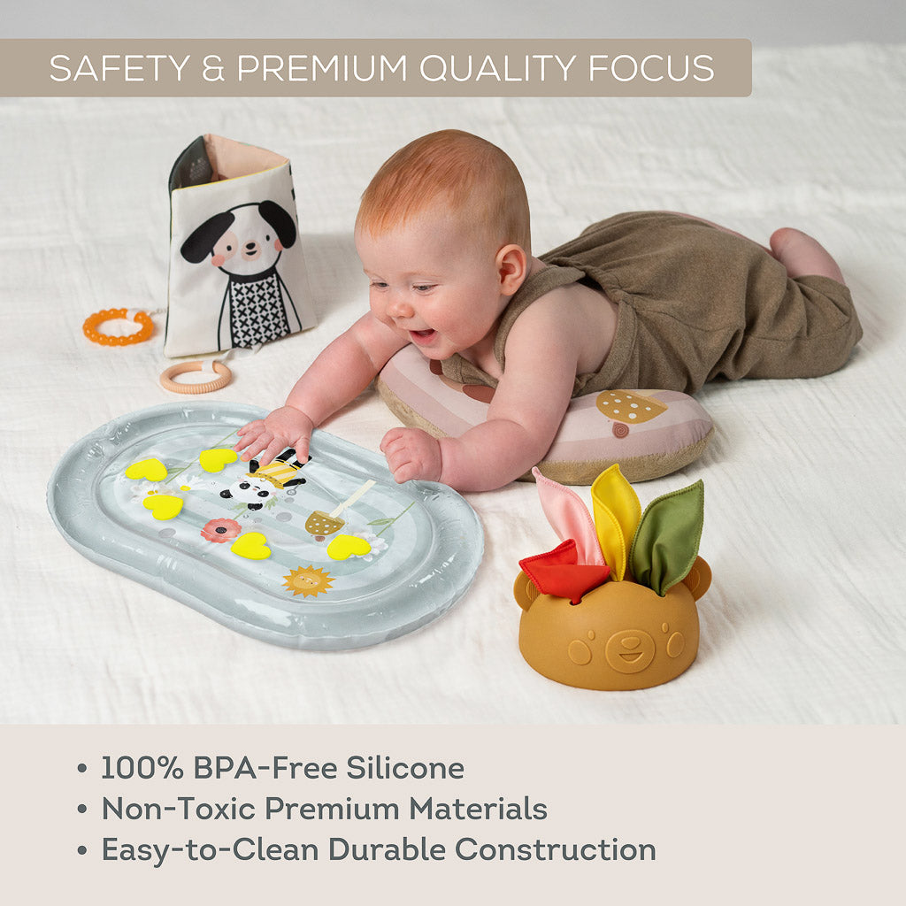 Baby playing with Taf Toys tummy time kit highlighting 100% BPA-free non-toxic easy-to-clean materials